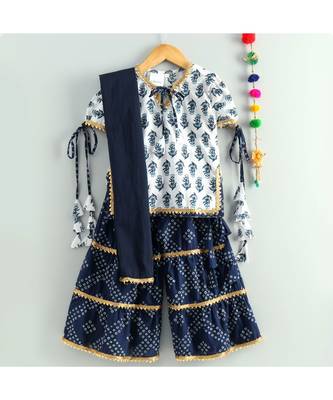 white printed kurti with a triple layered bandhini sharara and a blue dupatta 2
