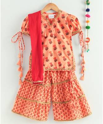floral peach kurti with a triple layered sharara and a red dupatta 1