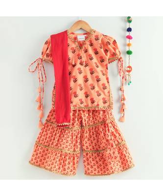 floral peach kurti with a triple layered sharara and a red dupatta 3