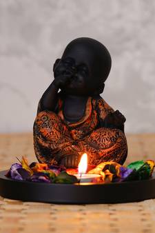 eCraftIndia Decorative Smiling Copper Monk Buddha with Wooden Base, Fragranced Petals and Tealight