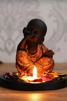 eCraftIndia Decorative Smiling Copper Monk Buddha with Wooden Base, Fragranced Petals and Tealight