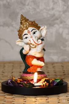 eCraftIndia Colorful Lord Ganesha Dancing Avatar Decorative Showpiece with Wooden Base, Fragranced Petals and Tealight