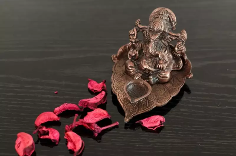 Metal Lord Ganesha with Diya on Leaf