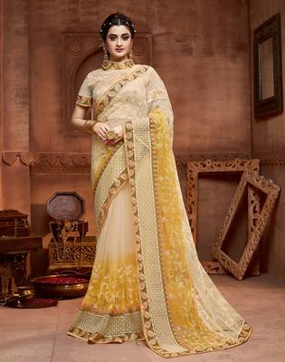 Cream embroidered net saree with blouse 1