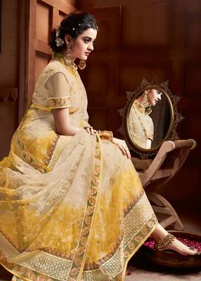 Cream embroidered net saree with blouse 2