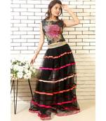 black net skirt with pink handmade silk ribbons and printed blouse with black slacks