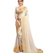 Cream embroidered satin saree with blouse