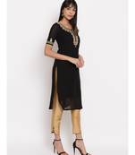 Black georgette hand embroidered kurti paired with beige silk trouser