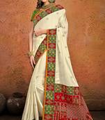 Cream embroidered satin saree with blouse