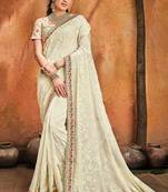 Cream embroidered georgette saree with blouse