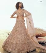 Peach embroidered net semi stitched lehenga