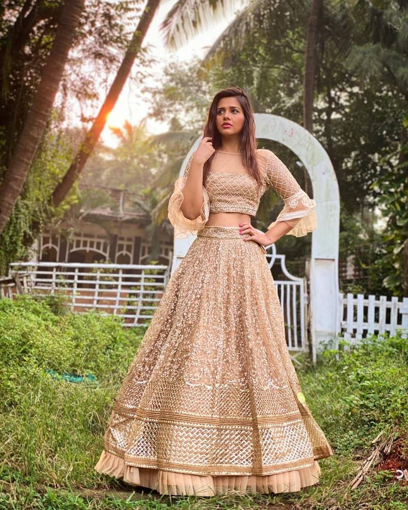 Beige embroidered net semi stitched lehenga