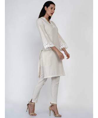 women off white cotton flex v neck kurta with lace work on neck and sleeve hem 1