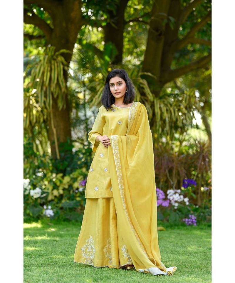 Yellow short kurta with Sharara and georgette dupatta