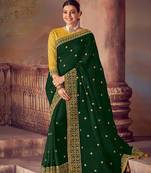 Dark green embroidered silk saree with blouse