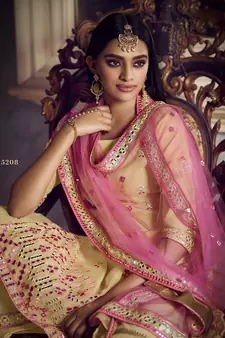 Beige Colored Thread Embroidered With Foil Mirror Work Organza Gharara Type Sharara Suit For Festive