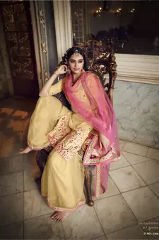 Beige Colored Thread Embroidered With Foil Mirror Work Organza Gharara Type Sharara Suit For Festive