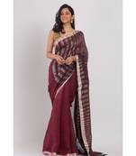Maroon linen saree with silver zori pallu and border