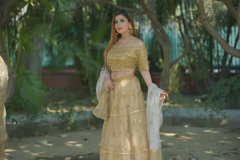 ALL OVER SITARA GOLD LEHENGA WITH OFF SHOULDER BLOSE IN CASCADING BEADED BLOUSE