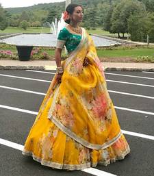 yellow floral organza lehenga with green embroidered choli