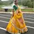 yellow floral organza lehenga with green embroidered choli