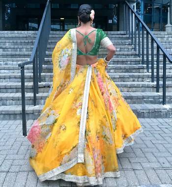 yellow floral organza lehenga with green embroidered choli 2