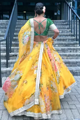 yellow floral organza lehenga with green embroidered choli