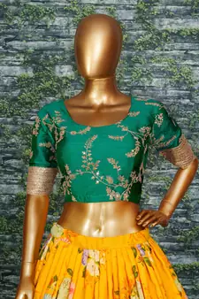 yellow floral organza lehenga with green embroidered choli
