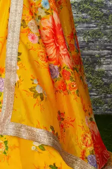 yellow floral organza lehenga with green embroidered choli