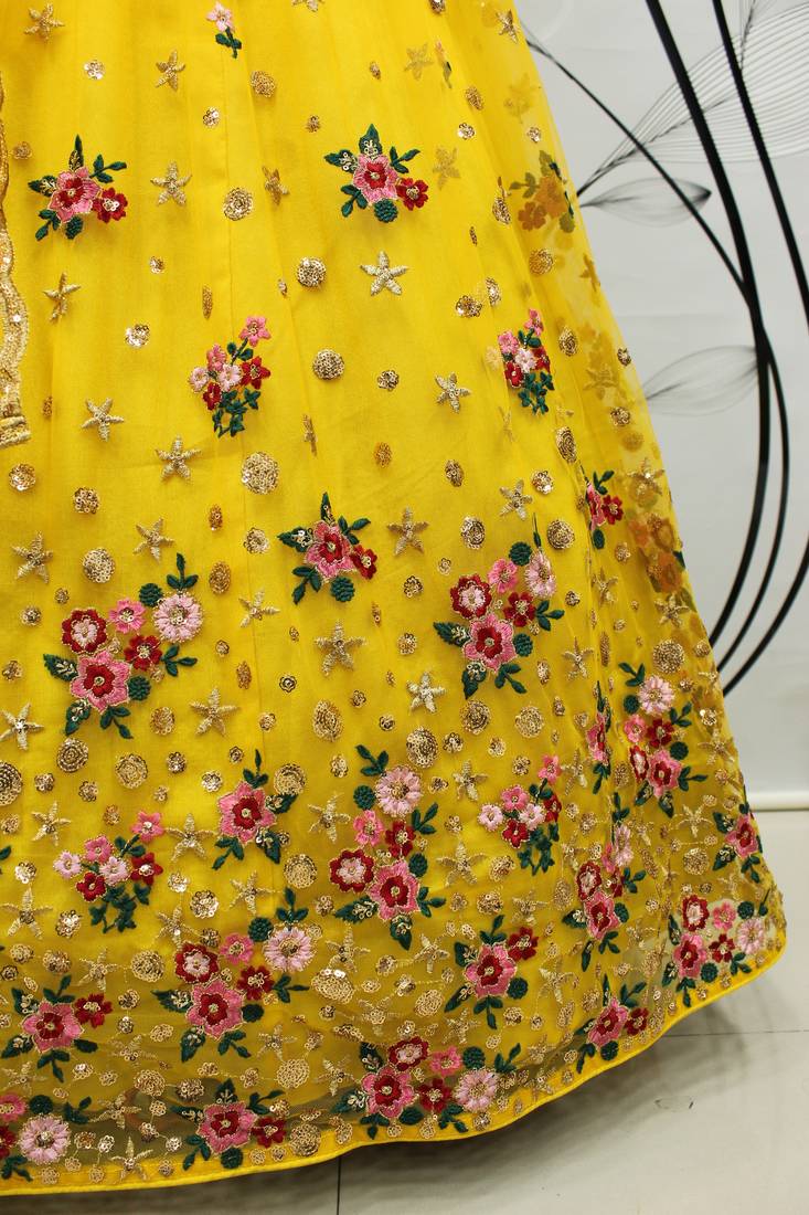 Yellow embroidered net semi stitched ceremonial lehenga