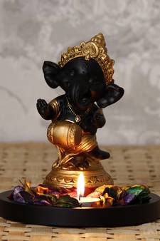 Golden and Black Lord Ganesha Dancing Avatar DECORative Showpiece with Wooden Base  Fragranced Petals and Tealight