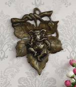 eCraftIndia Antique Finish Lord Ganesha on Creative Leaf Handcrafted Metal Wall Hanging