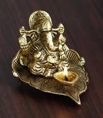 eCraftIndia Golden Lord Ganesha with Diya on Leaf Handcrafted Metal Showpiece