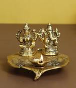 eCraftIndia Golden Laxmi Ganesha with Diya on Leaf Handcrafted Metal Showpiece