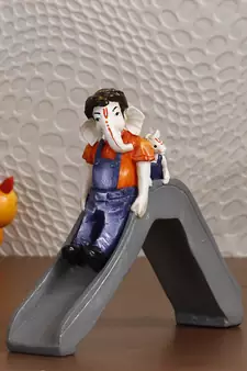 eCraftIndia Lord Ganesha Enjoying Slide with Mushak Colorful Handcrafted DECORative Figurine
