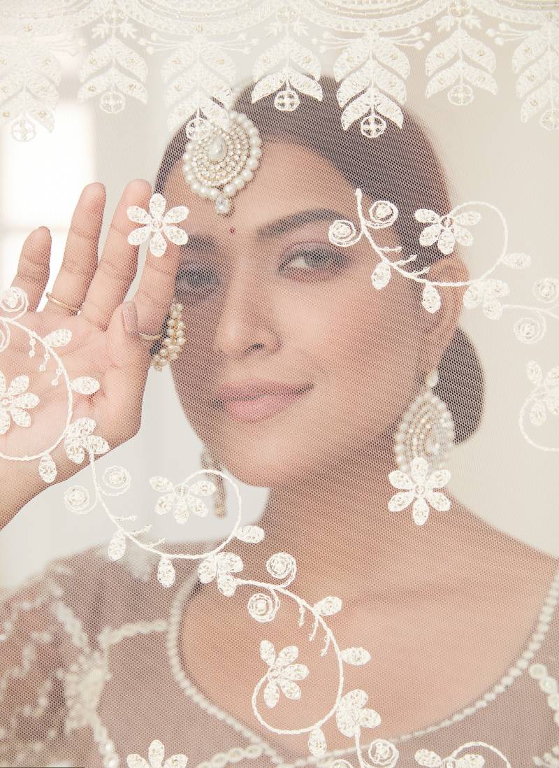 Seductive Beige colored thread with sequins embroidered Heavy Non-non Net Wedding Lehenga choli