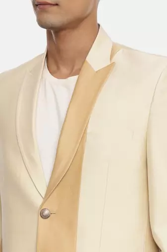 gold beige two button blazer for a sangeet evening . pair with ivory pants to complete the look.