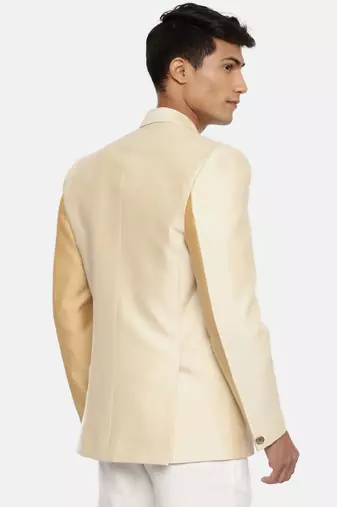 gold beige two button blazer for a sangeet evening . pair with ivory pants to complete the look.