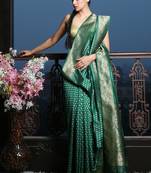 Dark green silk saree with golden border and buti