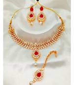 Gold plated jewelry set with earrings and Maangtikka in Maroon color