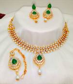 Gold plated jewelry set with earrings and Maangtikka in Green color