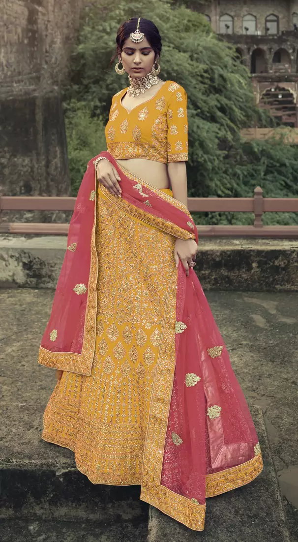 Captivating Yellow Colored Dori, Zari, and Thread Embroidered with stone work satin Lehenga choli for wedding