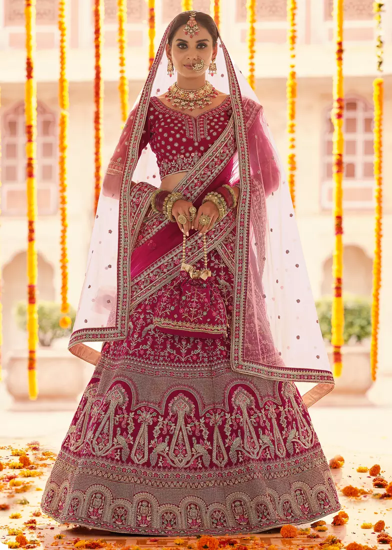 Pink Zari, zarkan, zardosi and thread embroidered velvet semi stitched wedding lehenga